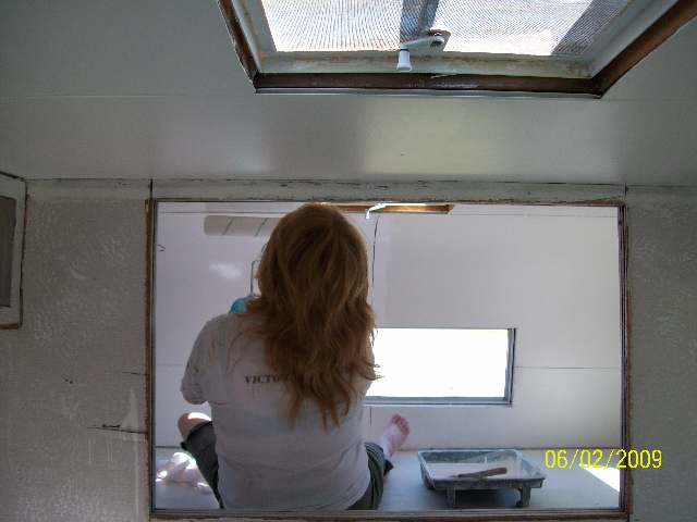 My wife helping to renovate our old camper.