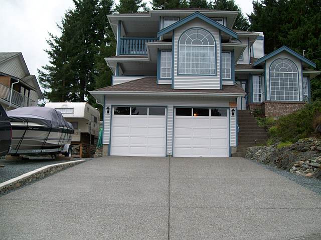 Photo of the front of Daves house showing the concrete driveway and curb.